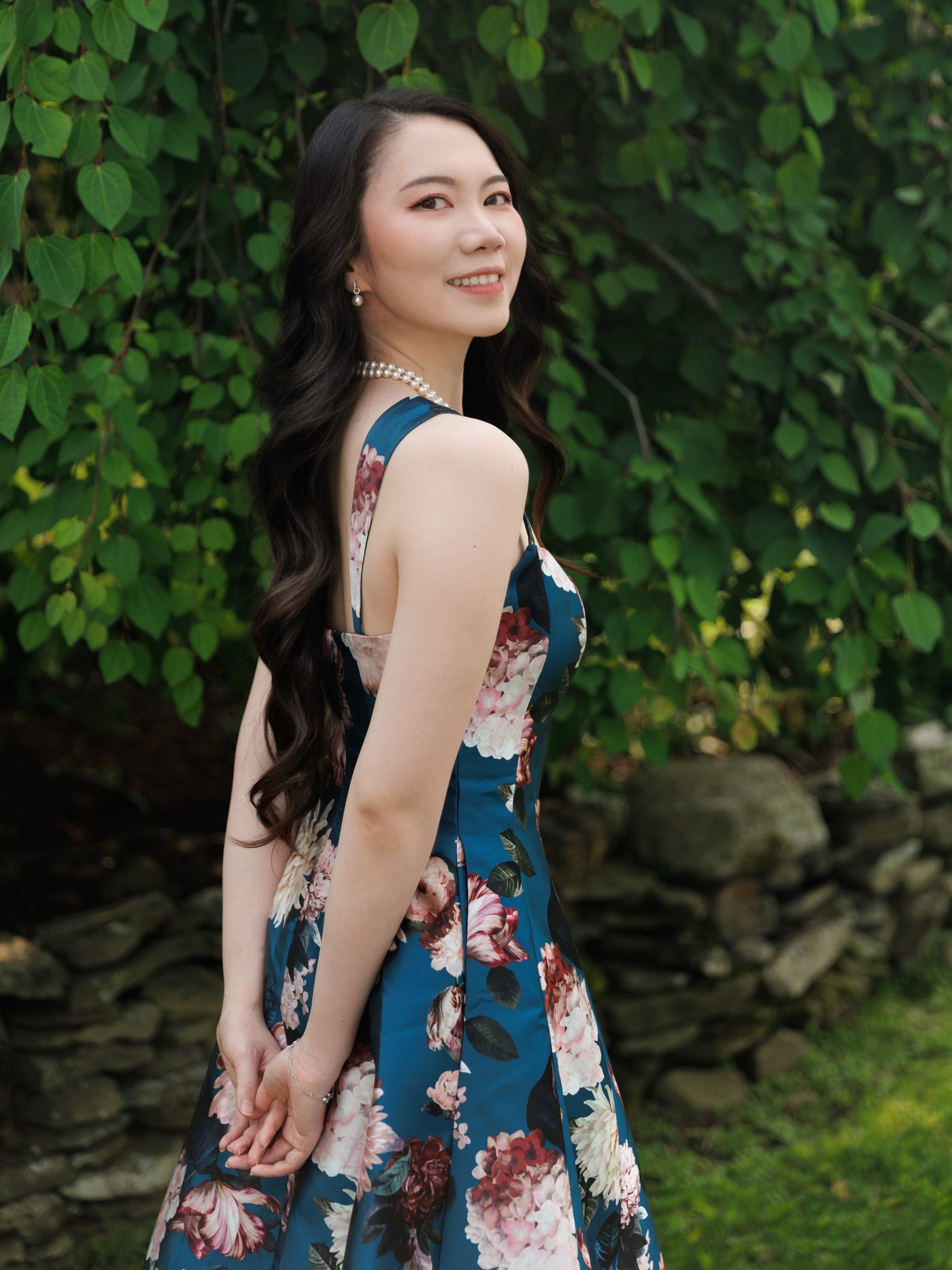 Portrait of mezzo-soprano Xiao Xiao in a teal floral gown